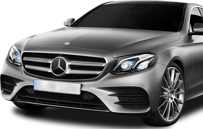 A front-side view of a silver Mercedes-Benz sedan with tinted windows and LED headlights, showcasing its elegant grille, sporty design, and premium alloy wheels on a transparent background.